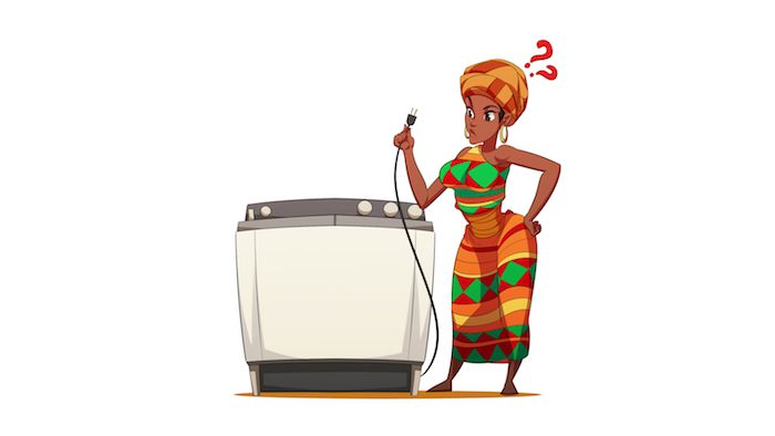 A woman from Africa looking confused holding the power cord of a washing machine.